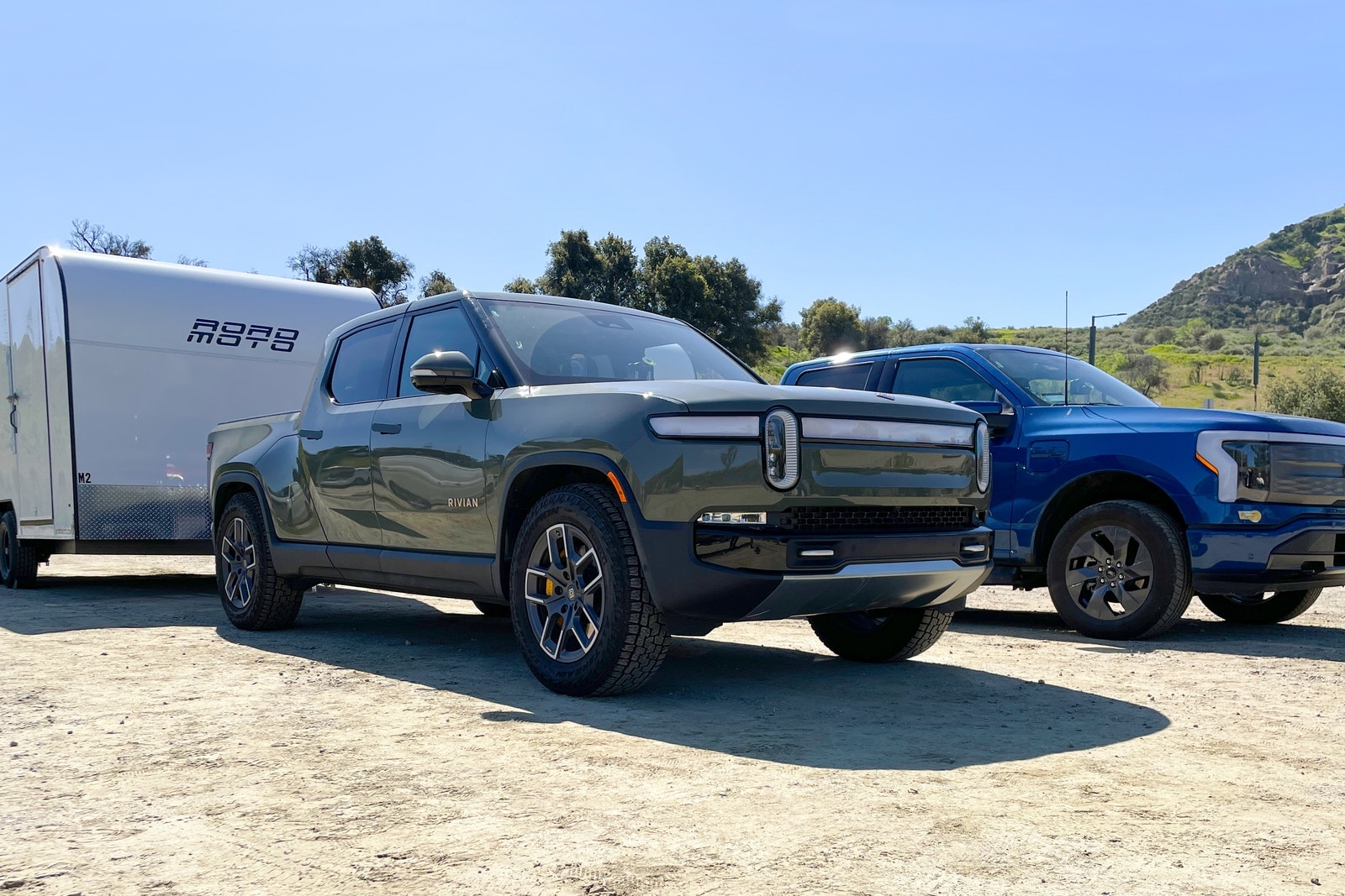 Rivian R1T and Ford F-150 Lightning parked side by side