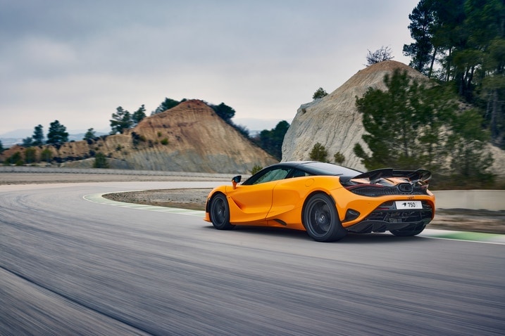 2024 McLaren 750S Coupe driving, rear three-quarter view