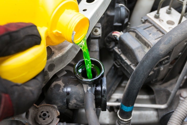 Coolant being poured into engine