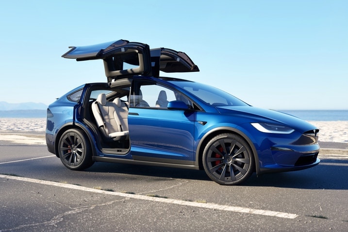 A Tesla Model X with falcon-wing doors open