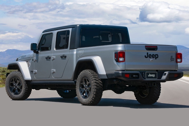 Rear quarter view of a silver 2023 Jeep Gladiator Willys Sport with the optional hardtop