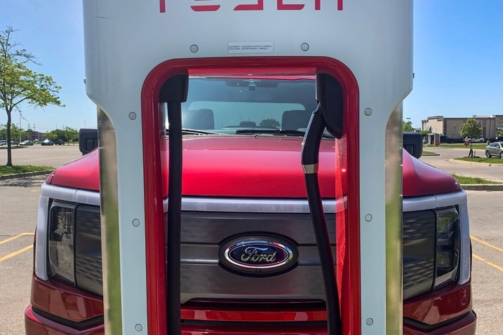 2023 Ford F-150 Lightning charging at a Tesla Supercharger