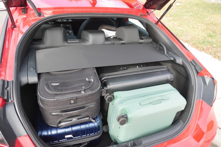 Five suitcases underneath the cargo cover in the Honda Civic Hatchback