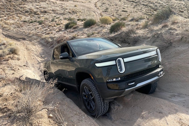 Rivian R1T on an uphill rut