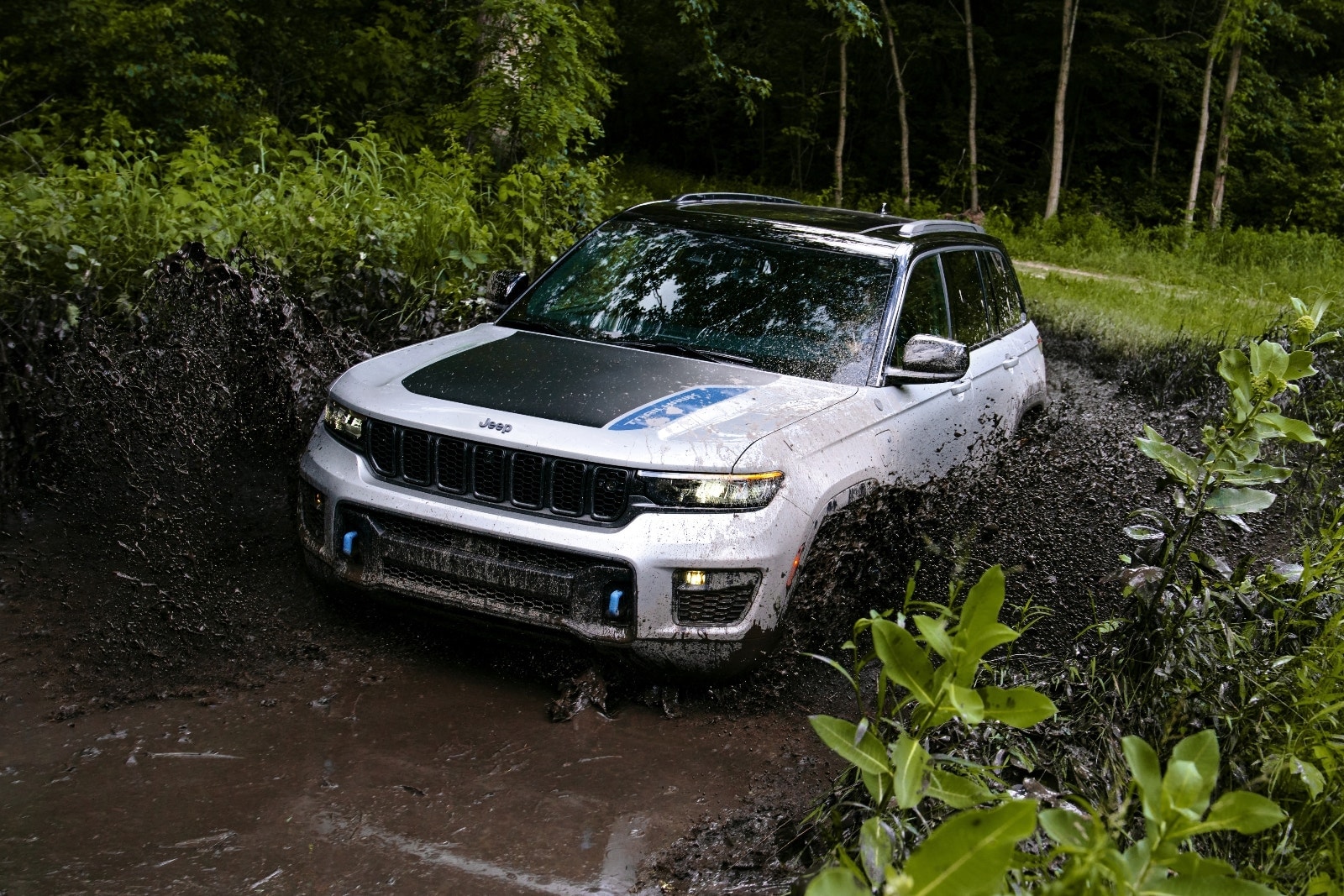 2023 Jeep Grand Cherokee 4xe Trailhawk white driving in mud