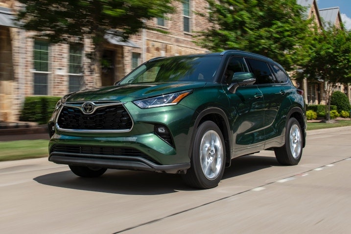 2023 Toyota Highlander in green, driving on a street