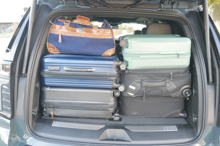Six suitcases in back of Chevy Tahoe
