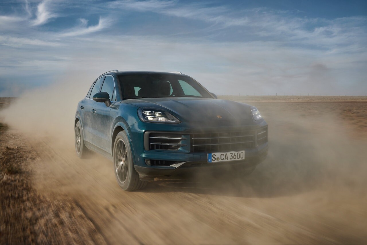 2024 Porsche Cayenne driving on a dusty road