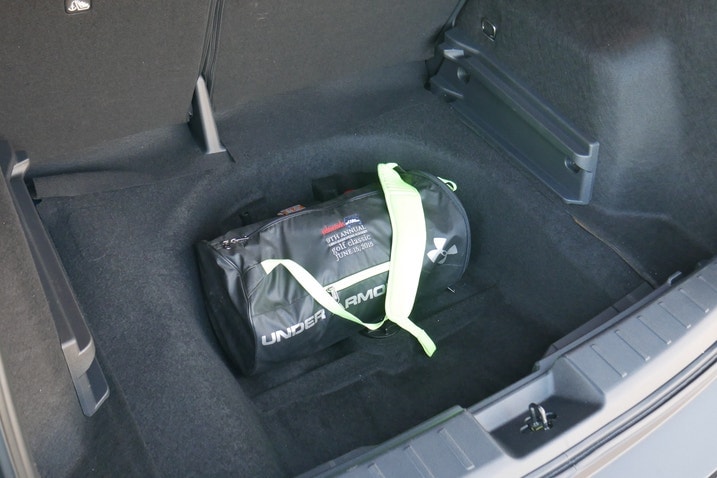 A duffle bag in spare tire well in Nissan Kicks