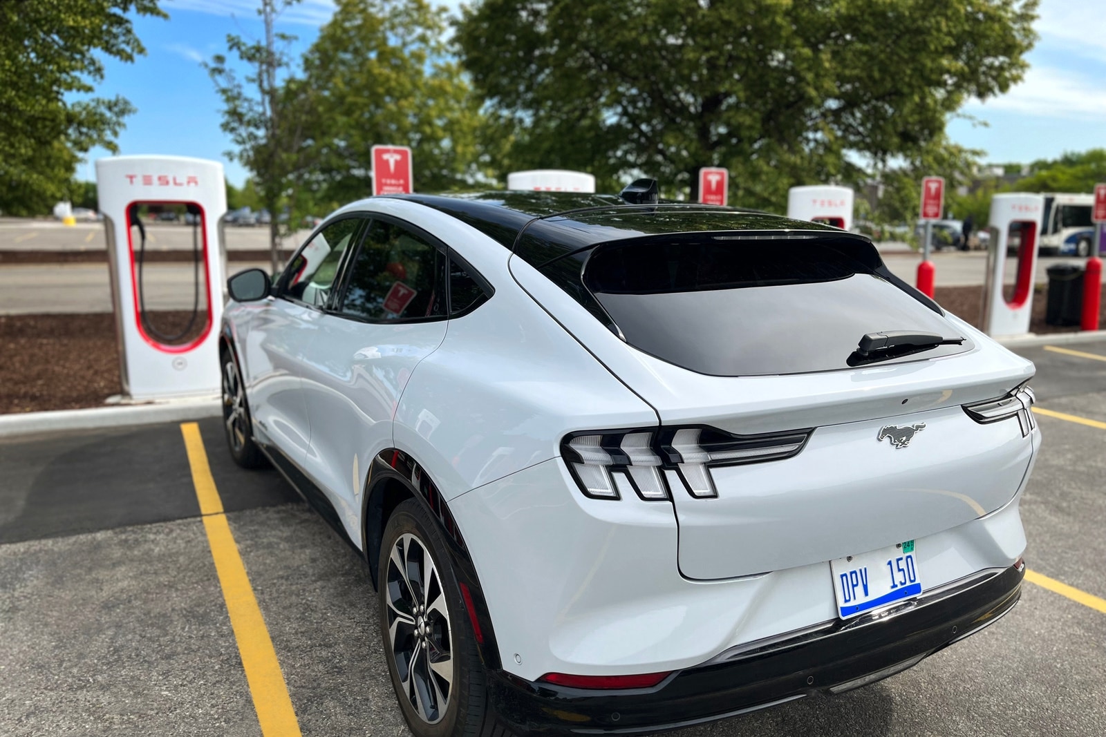 2023 Ford Mustang Mach-E charging at a Tesla Supercharger