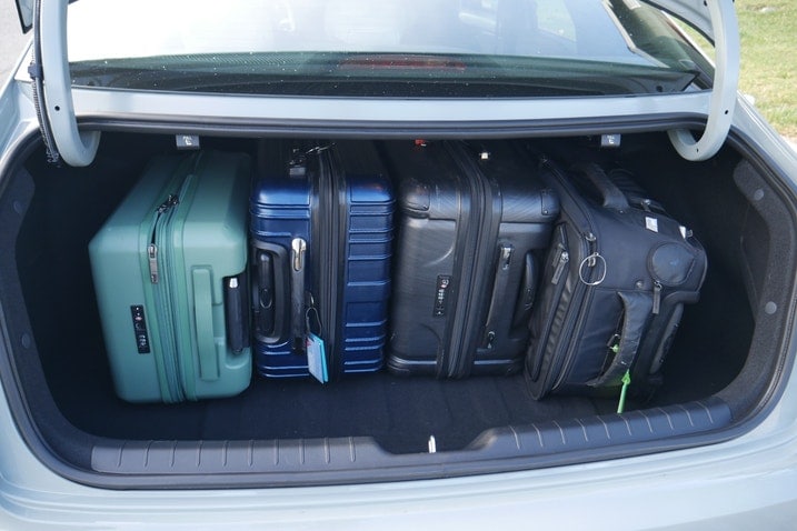 Four suitcases in a Kia K4 trunk