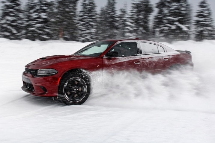 2023 Dodge Charger GT AWD drifting through snow on a winter day