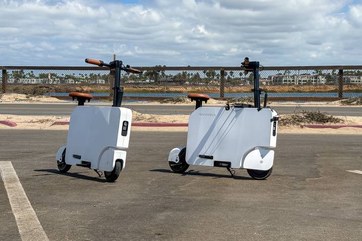 Two 2024 Honda Motocompactos parked outdoors by the beach