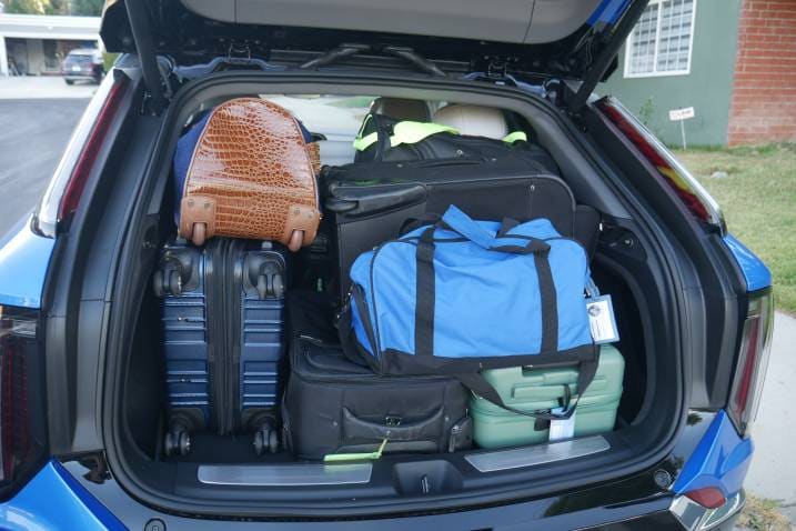 Five suitcases and three duffel bags in a Cadillac Optiq