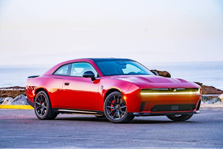An image of a 2024 Dodge Charger Daytona EV parked outdoors by the beach.
