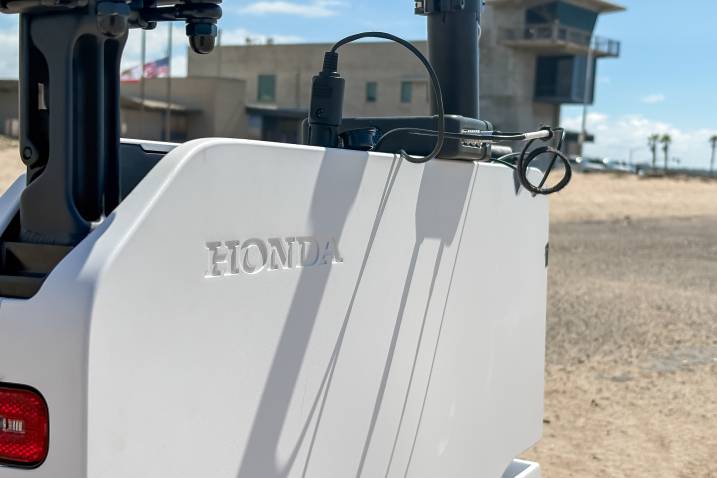 2024 Honda Motocompacto parked outdoors by the beach.