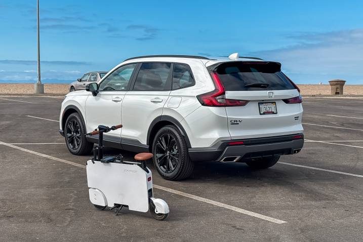 2024 Honda Motocompacto parked outdoors by the beach next to a CR-V
