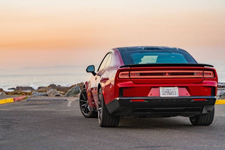 An image of a 2024 Dodge Charger Daytona EV parked outdoors by the beach.