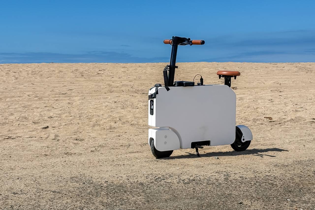 2024 Honda Motocompacto parked outdoors by the beach.