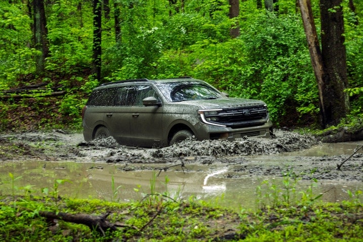 2025 Ford Expedition driving through mud. Front view