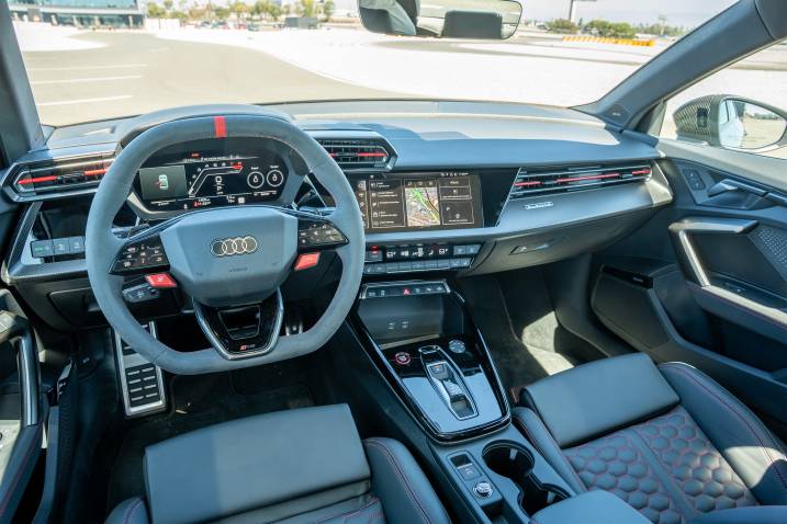 A close-up of a 2025 Audi RS 3's interior while parked at a test track.