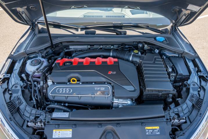 A close-up of a 2025 Audi RS 3's engine while parked at a test track.