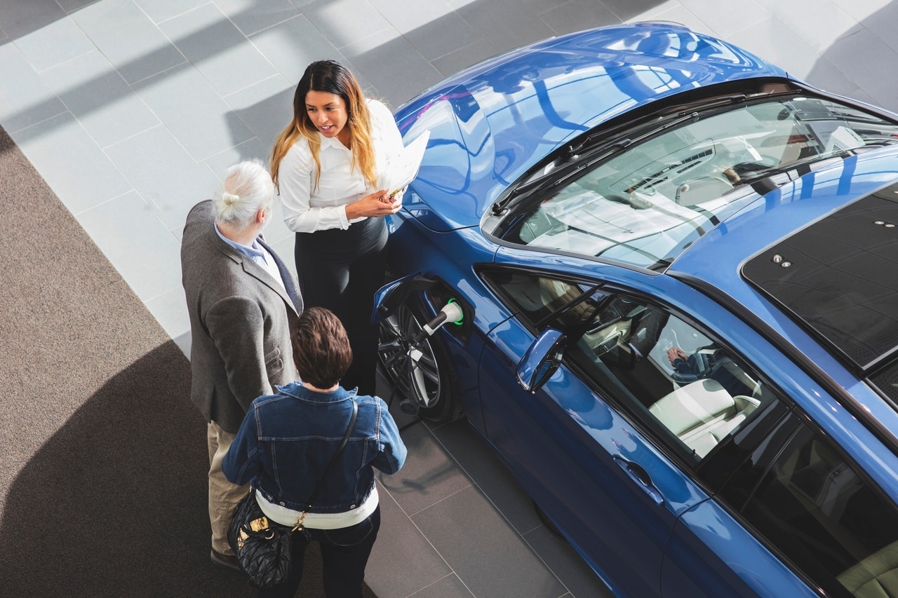 Shoppers inside a car dealership